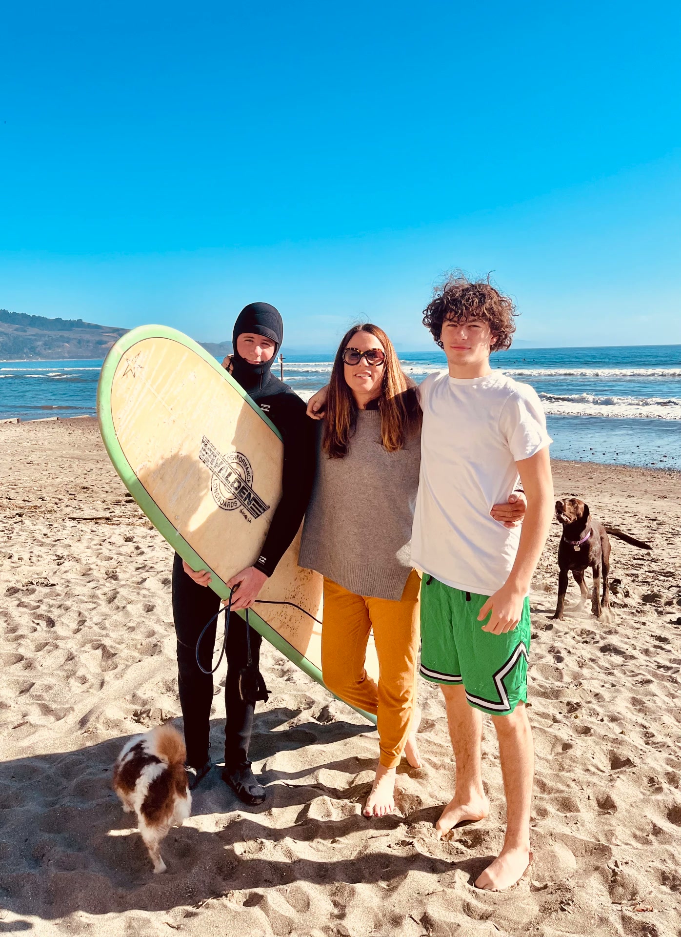 Sharon with her boys and dogs on a sunny California beach