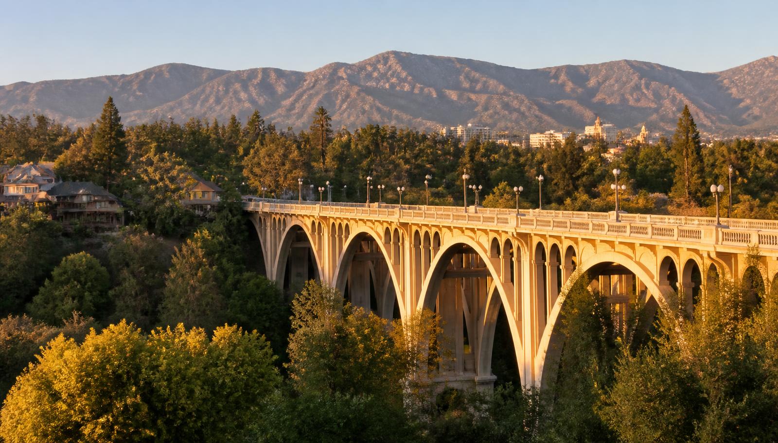 The Colorado Street Bridge with the San Gabriel Mountains behind it at golden hour